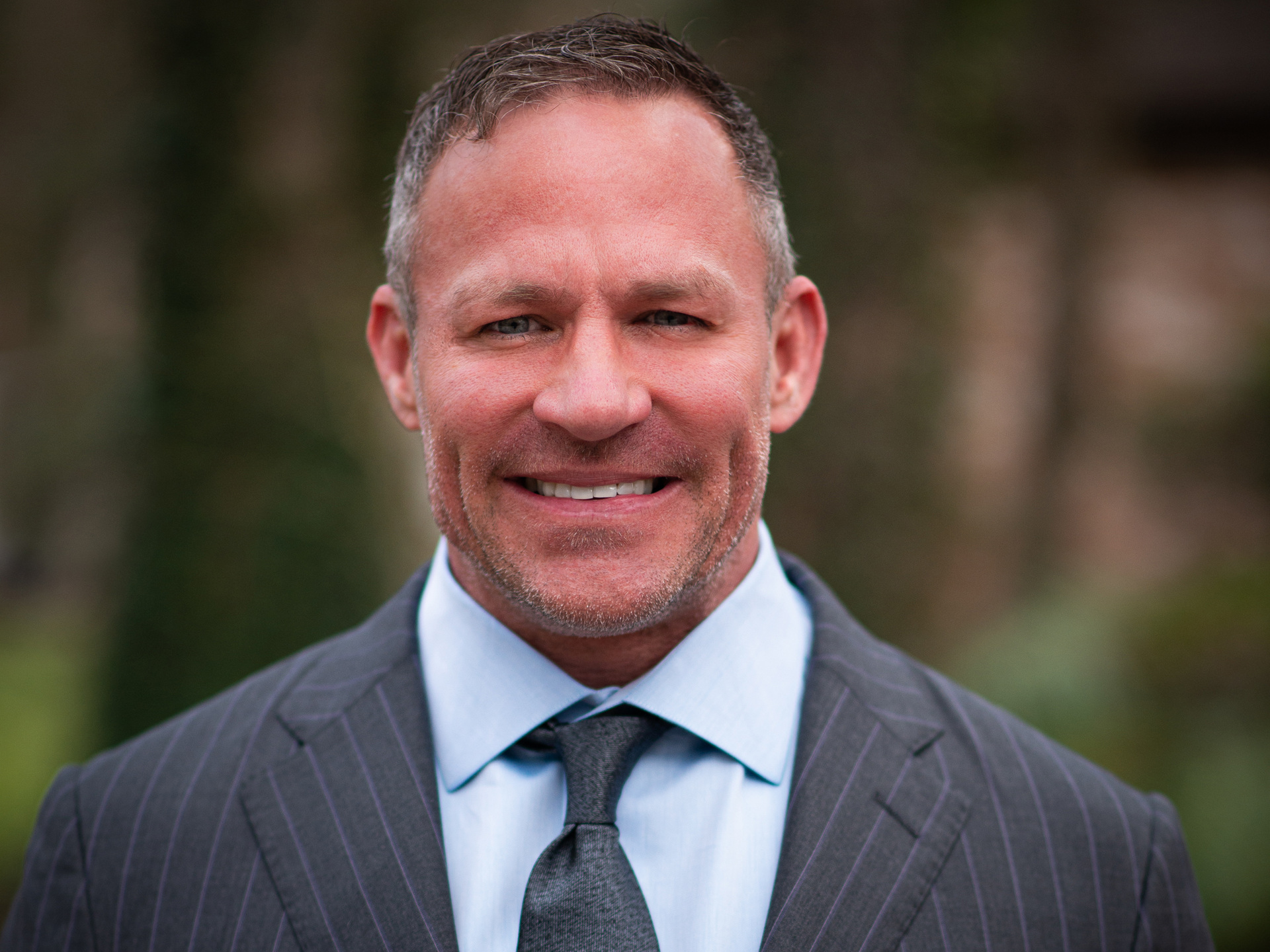Professional headshot of a businessman in a suit